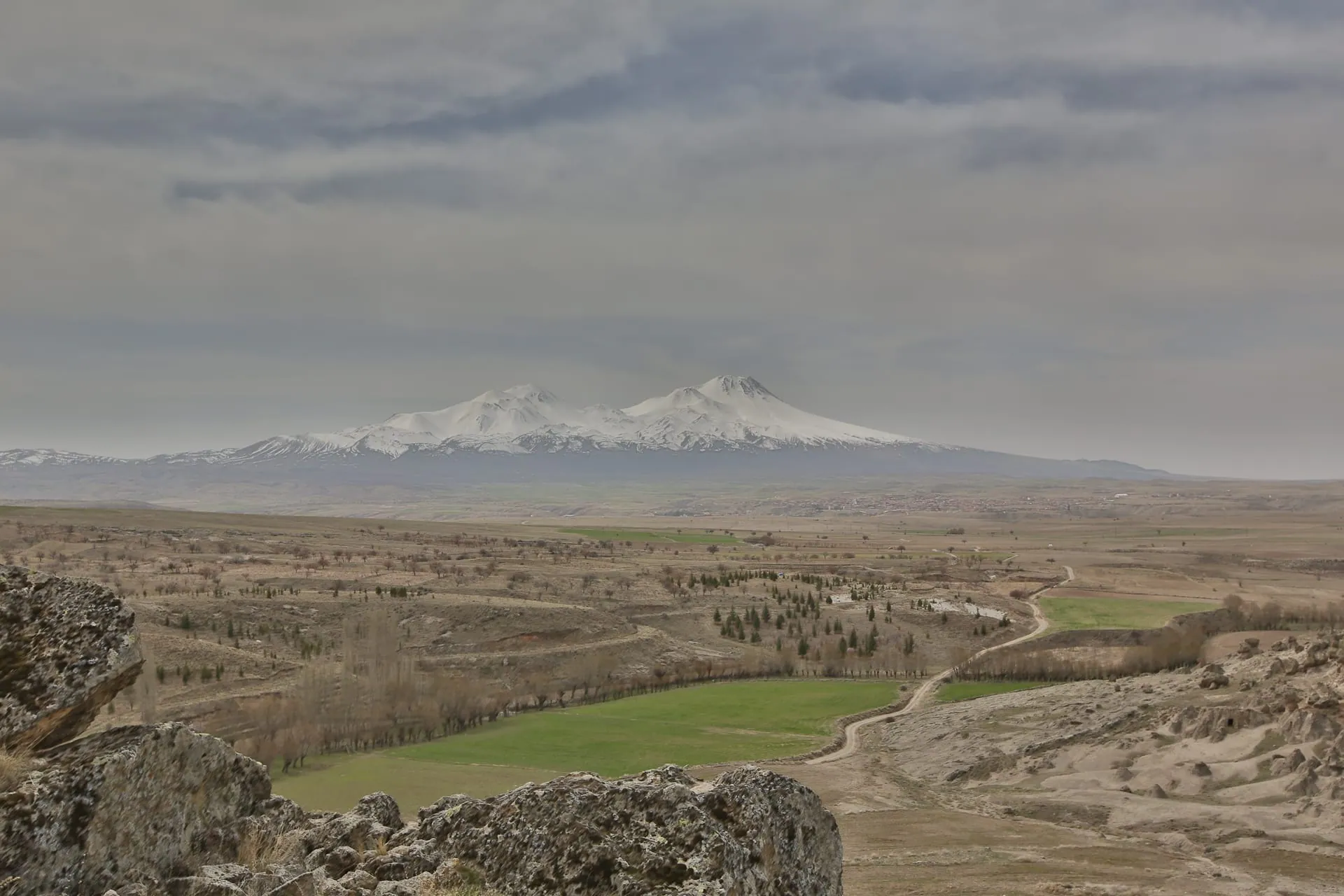 The twin summits of snow-covered Mount Hasan volcano